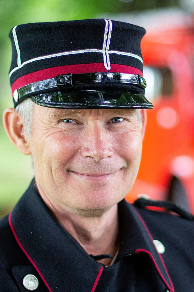 Portrettbilde av Roy Larsen i en gammel brannkonstabeluniform.